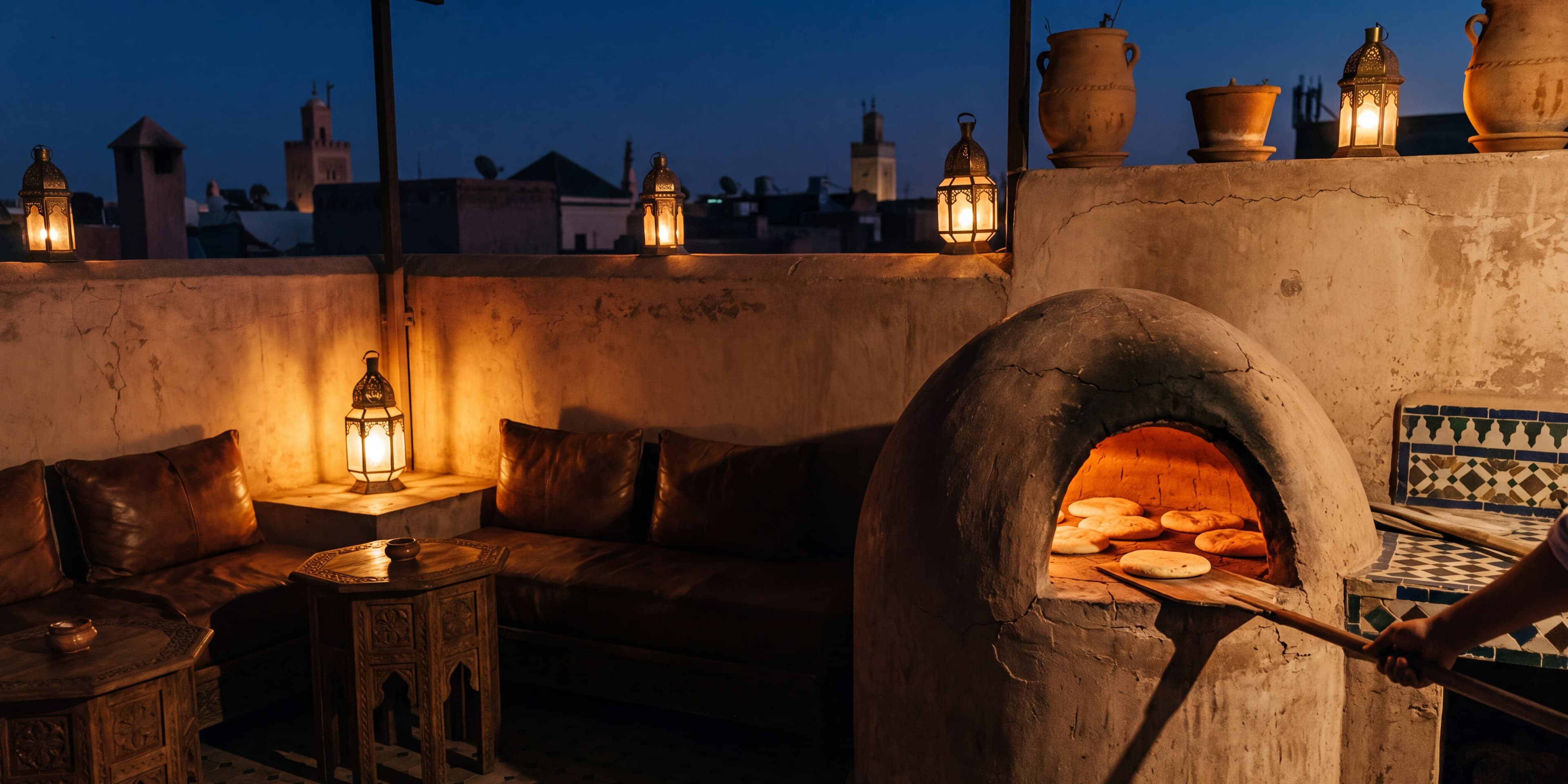 A domed clay oven glowing orange, flatbreads rising inside, on the roof at night.